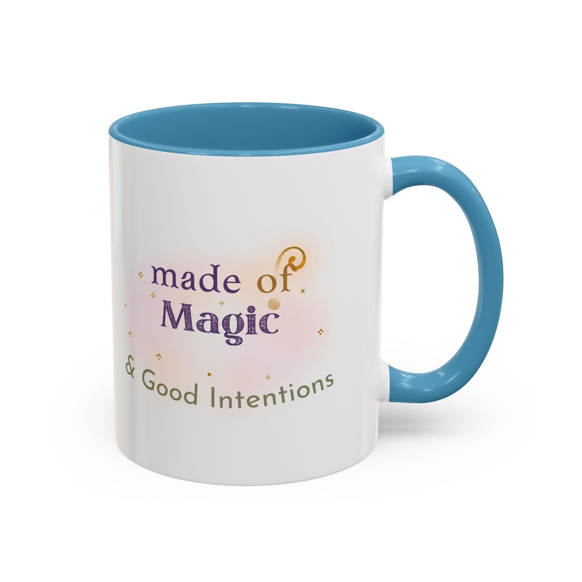 Jena Jewelry white ceramic mug with blue interior and handle, featuring "Made of Magic & Good Intentions" text and watercolor accents.