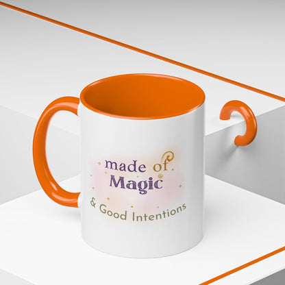 Jena Jewelry white ceramic mug with orange interior and handle, featuring "made of Magic & Good Intentions" text.