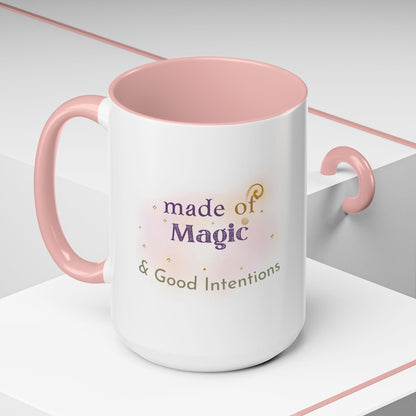 Jena Jewelry white ceramic mug with pink interior and handle, featuring "Made of Magic & Good Intentions" text and watercolor accents.