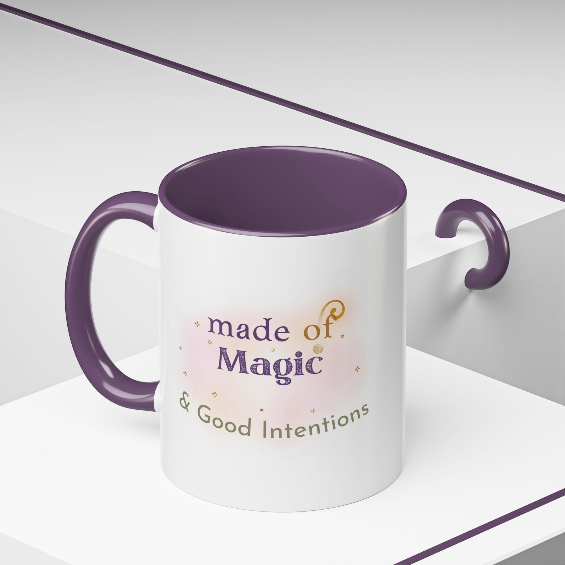 Jena Jewelry white ceramic mug with purple interior and handle, featuring "made of Magic & Good Intentions" text.