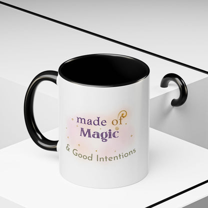 Jena Jewelry white ceramic mug with black interior and handle, featuring "made of Magic & Good Intentions" text and watercolor design.