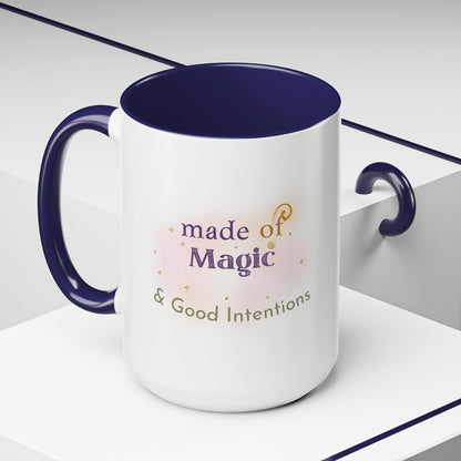 Jena Jewelry white ceramic mug with navy blue interior and handle, featuring "Made of Magic & Good Intentions" text and watercolor accents.