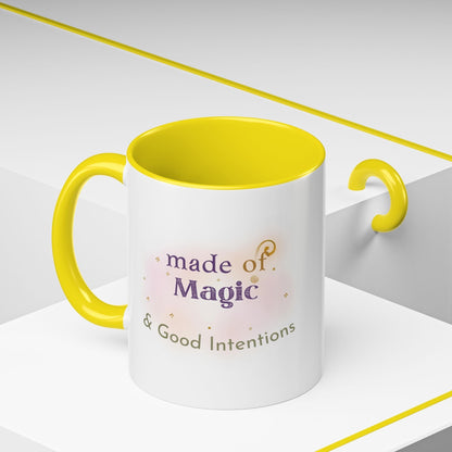 Jena Jewelry white ceramic mug with yellow interior and handle, featuring "made of Magic & Good Intentions" text.