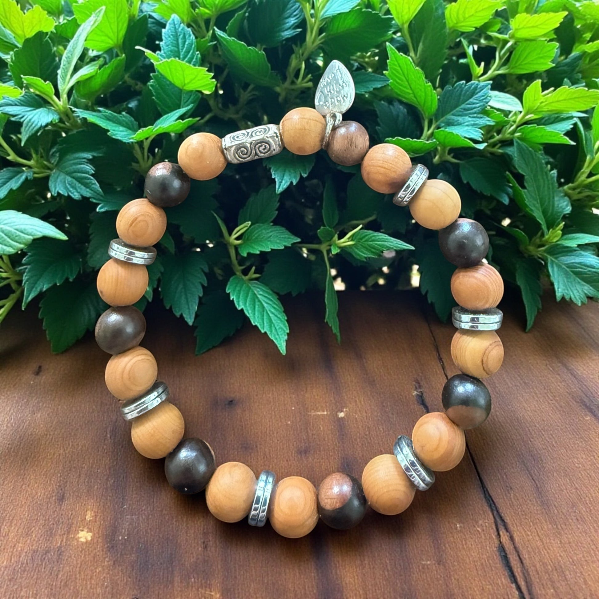 Jena Jewelry stretch bracelet with dark brown Tiger Ebony and light brown Thuja Sutchuenensis wood beads, accented with silver spacers.