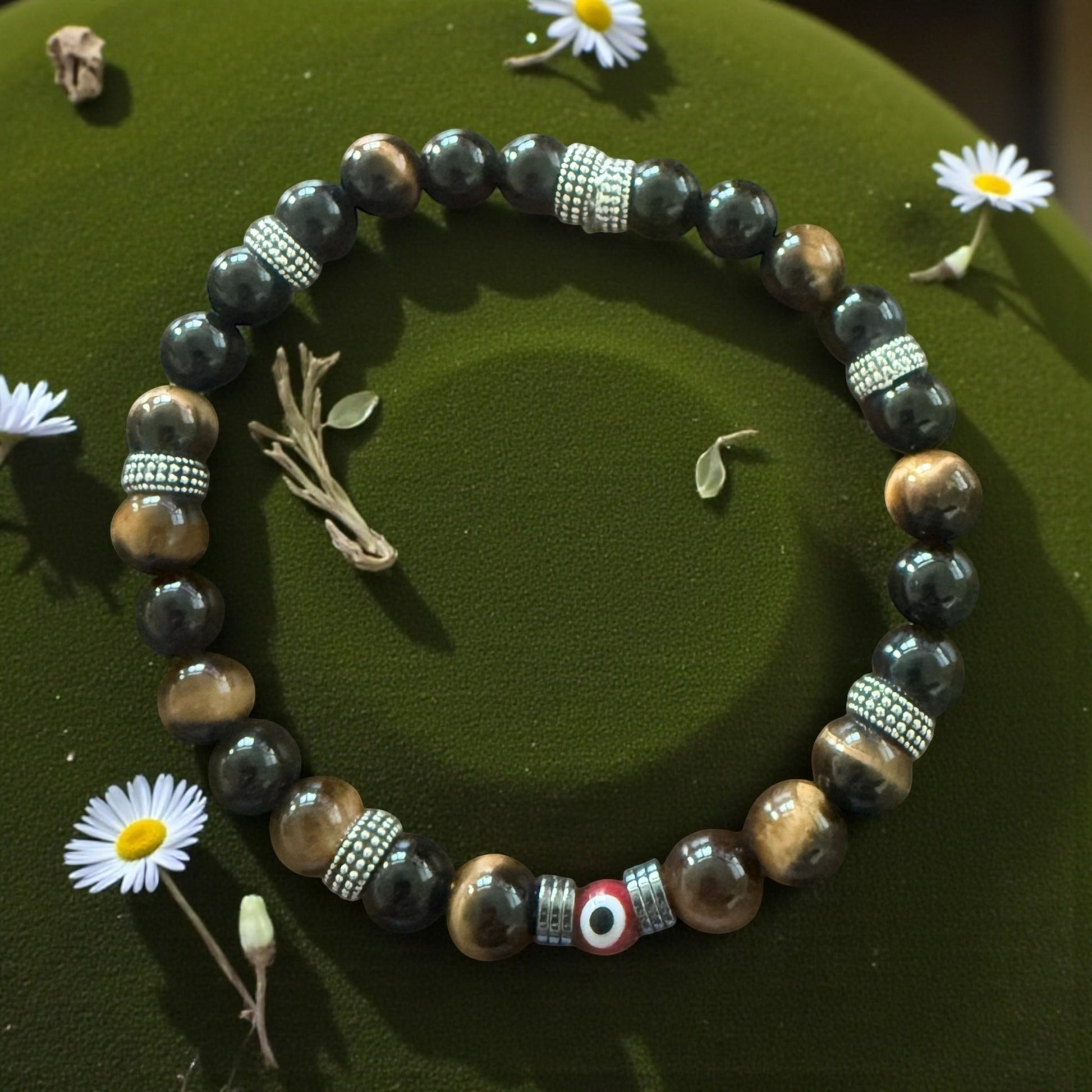 Jena Jewelry bracelet with tiger eye, black jade, and hematite beads spelling 'F*ck Off' in Morse code. Features a central evil eye charm.