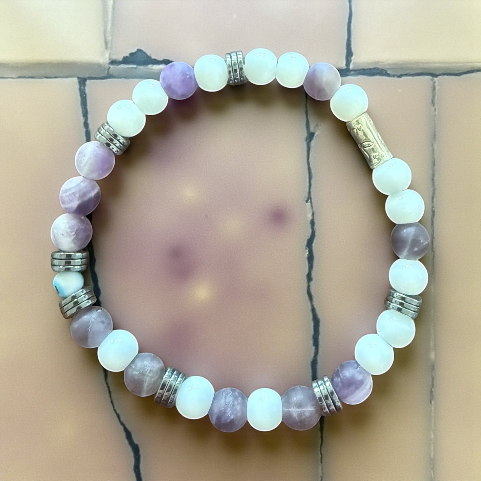 Jena Jewelry "F*ck Off" Morse code bracelet with white Snow Jade, purple Amethyst, and silver accent beads.