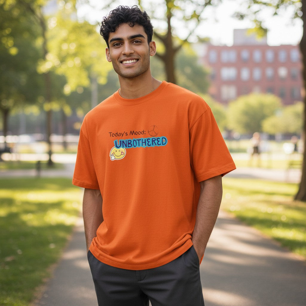 Jena Jewelry orange cotton t-shirt with "Today's Mood: UNBOTHERED" graphic and smiley face.