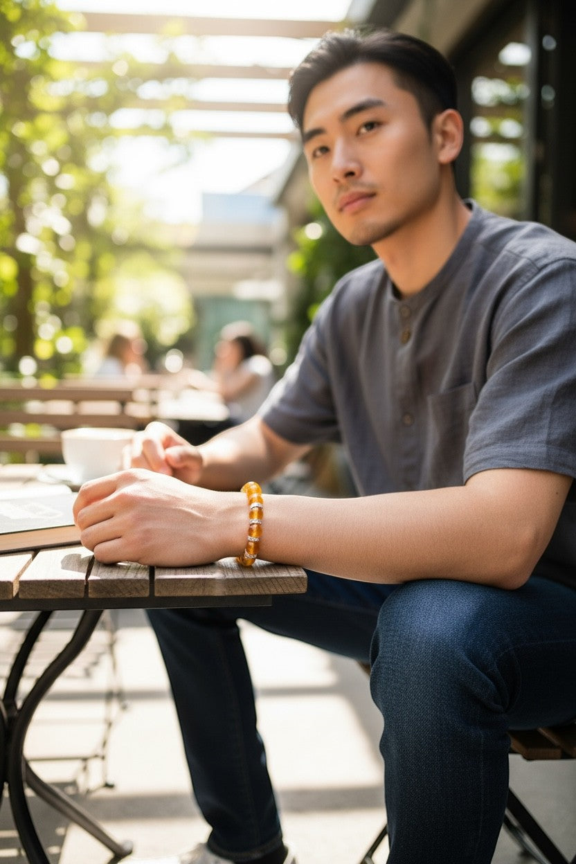 Jena Jewelry orange jade beaded bracelet with rhinestone spacers on a man's wrist, styled casually.