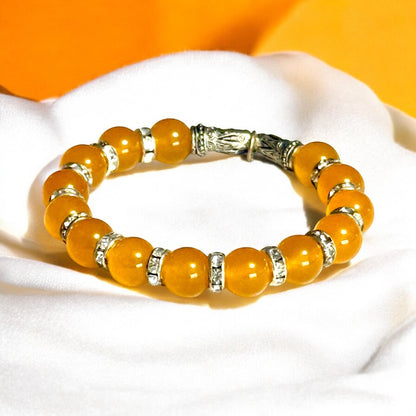 Jena Jewelry orange jade beaded bracelet with rhinestone spacers and silver accents, a playful and elegant accessory.