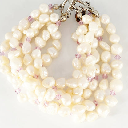 Jena Jewelry 6-strand freshwater pearl bracelet with purple crystals and silver toggle clasp. Classic bridal jewelry.