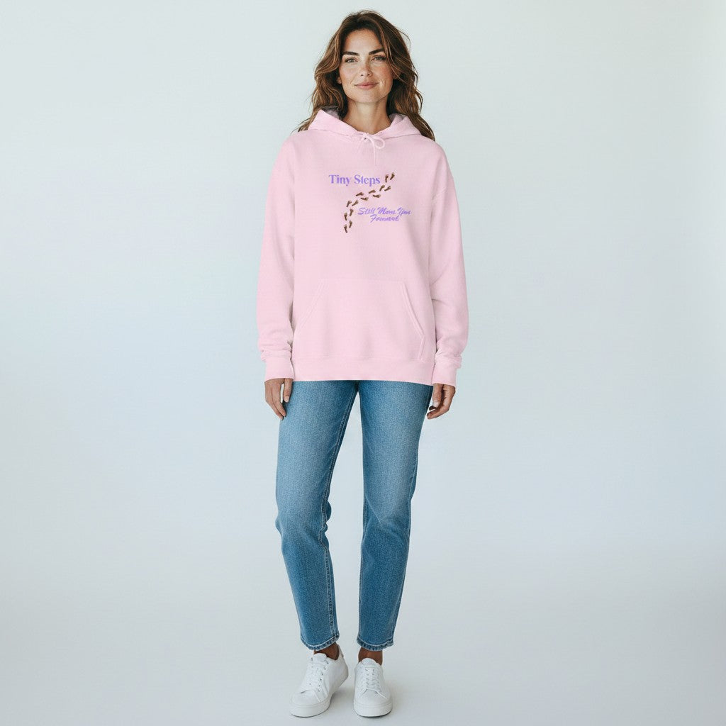 Jena Jewelry light pink cotton-poly blend hoodie with "Tiny Steps Still Move You Forward" graphic and footprint design.