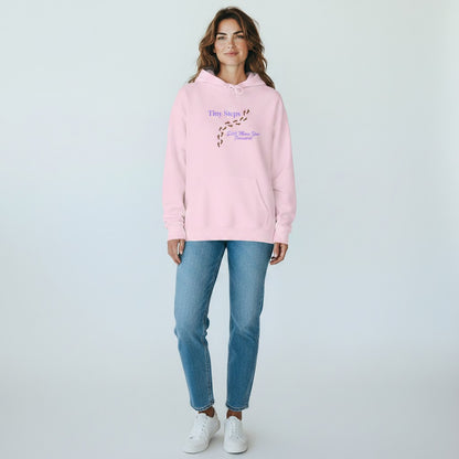 Jena Jewelry light pink cotton-poly blend hoodie with "Tiny Steps Still Move You Forward" graphic and footprint design.
