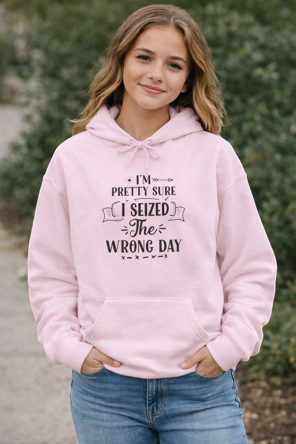 Jena Jewelry light pink pullover hoodie with a funny quote "I'm Pretty Sure I Seized the Wrong Day" in black text.