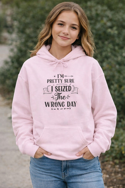 Jena Jewelry light pink pullover hoodie with a funny quote "I'm Pretty Sure I Seized the Wrong Day" in black text.