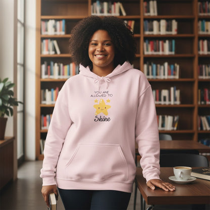Jena Jewelry light pink cotton-poly blend hoodie with a cute smiling star graphic and the text "You Are Allowed To Shine."