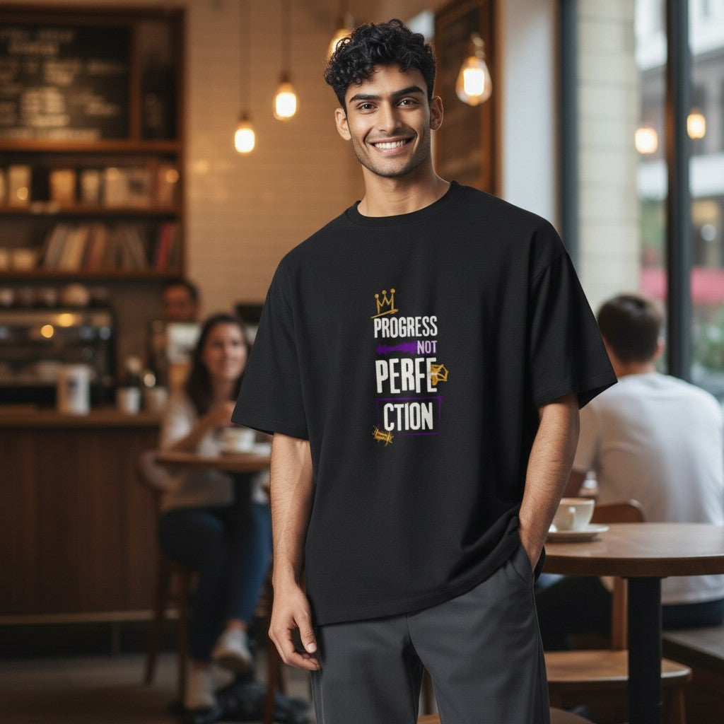 Jena Jewelry black 100% cotton t-shirt with a graphic print that says "Progress Over Perfection" in purple and gold.