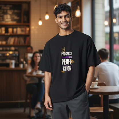 Jena Jewelry black 100% cotton t-shirt with a graphic print that says "Progress Over Perfection" in purple and gold.