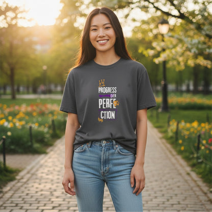 Jena Jewelry dark grey 100% cotton t-shirt with "Progress Over Perfection" graphic in purple and gold.