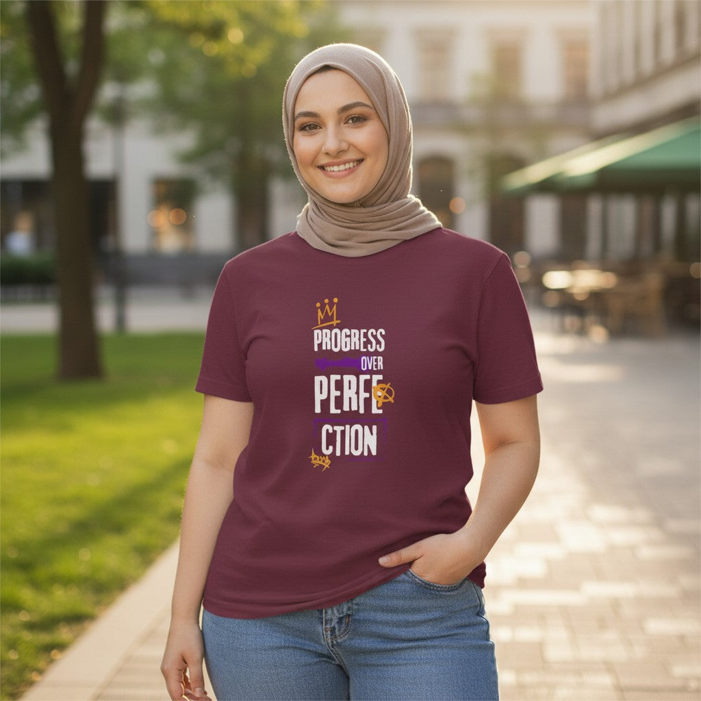 Jena Jewelry maroon 100% cotton t-shirt with "Progress Over Perfection" graphic in purple and gold. Relaxed fit, crew neck.
