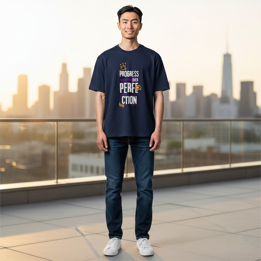 Jena Jewelry navy blue 100% cotton t-shirt with 'Progress Over Perfection' graphic in purple and gold. Relaxed fit, crew neck.