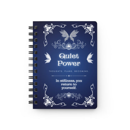 Jena Jewelry Quiet Power spiral notebook with a dark blue cover featuring ornate white filigree, butterflies, and inspirational text for personal growth and reflection.