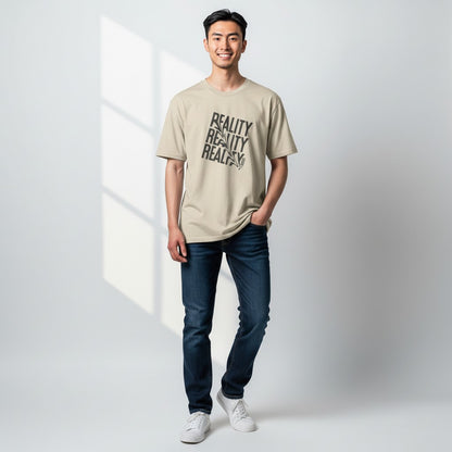 Jena Jewelry beige 100% cotton t-shirt with distressed diagonal "REALITY" graphic print and a small heart detail on the collar.