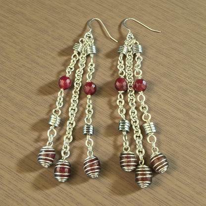 Jena Jewelry cascading red gemstone and silver strand earrings, 4 inches long, with faceted beads and striped barrel charms.