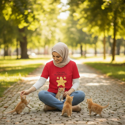 Jena Jewelry red 100% cotton t-shirt with "You Are Allowed to Shine" graphic and smiling star. Model wears it with jeans and a hijab.