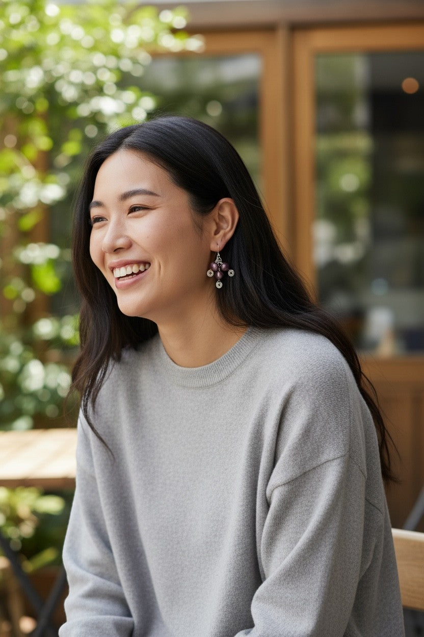 Jena Jewelry deep red freshwater pearl drop earrings with silver-tone wire wrapping, worn by a smiling woman.
