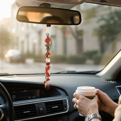 Jena Jewelry red and silver beaded car charm with jingle bells and a heart charm hanging from the rearview mirror.