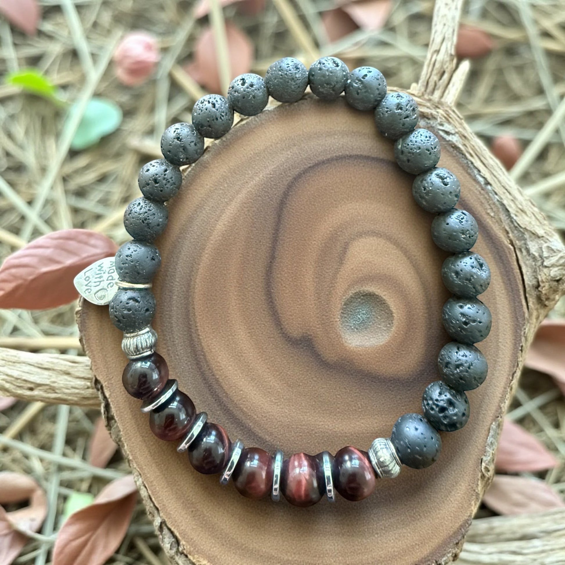 Jena Jewelry red tiger eye, hematite, and lava stone stretch bracelet with silver accents. Features a small heart charm.