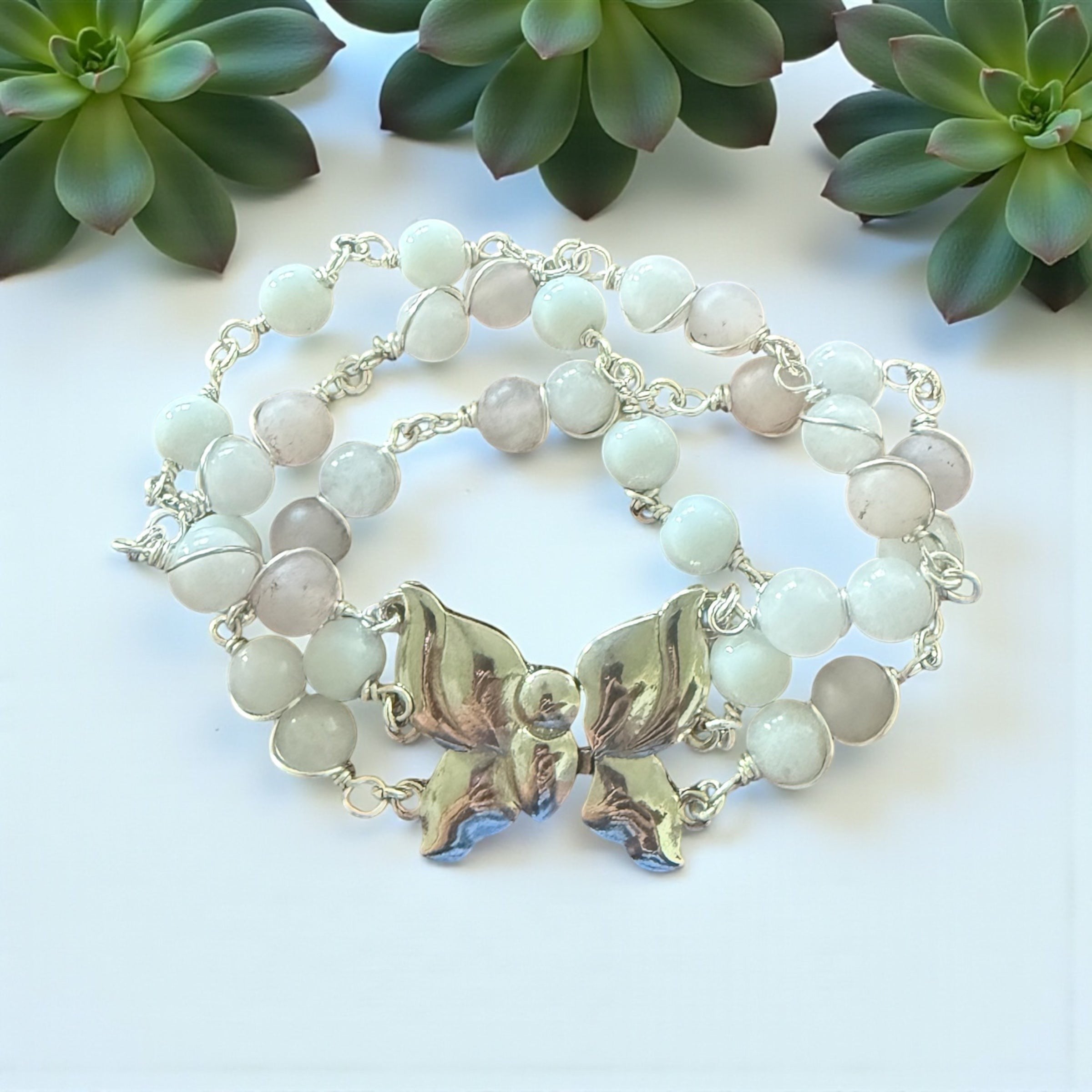 Jena Jewelry Rose Quartz & Snow Jade bracelet with butterfly clasp, featuring pale pink and light blue beads on a silver chain.