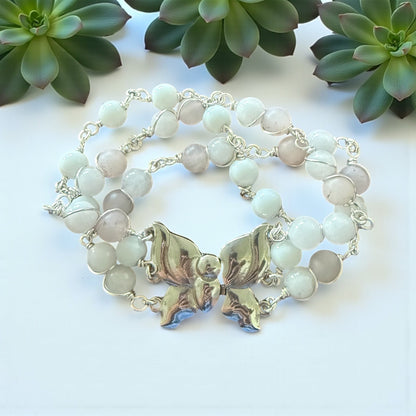 Jena Jewelry Rose Quartz & Snow Jade bracelet with butterfly clasp, featuring pale pink and light blue beads on a silver chain.