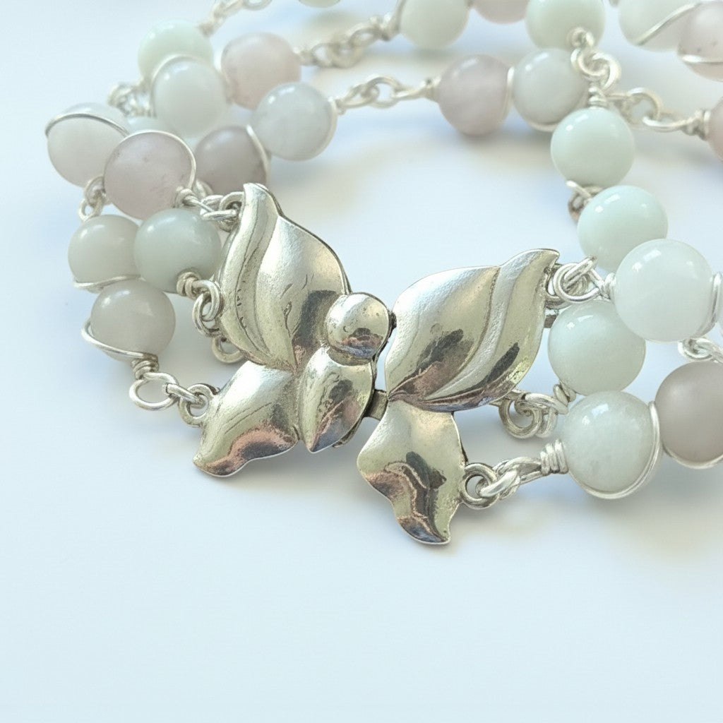 Jena Jewelry Rose Quartz & Snow Jade bracelet with silver butterfly clasp, symbolizing love and transformation.
