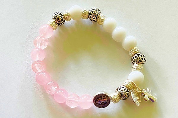 Jena Jewelry rosary bracelet with pink rose quartz and white snow jade beads, silver plate spacers, and a cross charm.