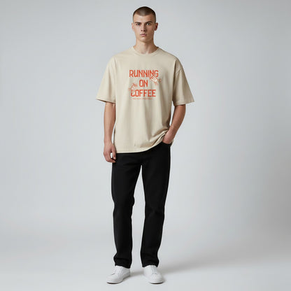 Jena Jewelry beige 100% cotton t-shirt with "Running on Coffee and Good Intentions" graphic and cartoon coffee cups.