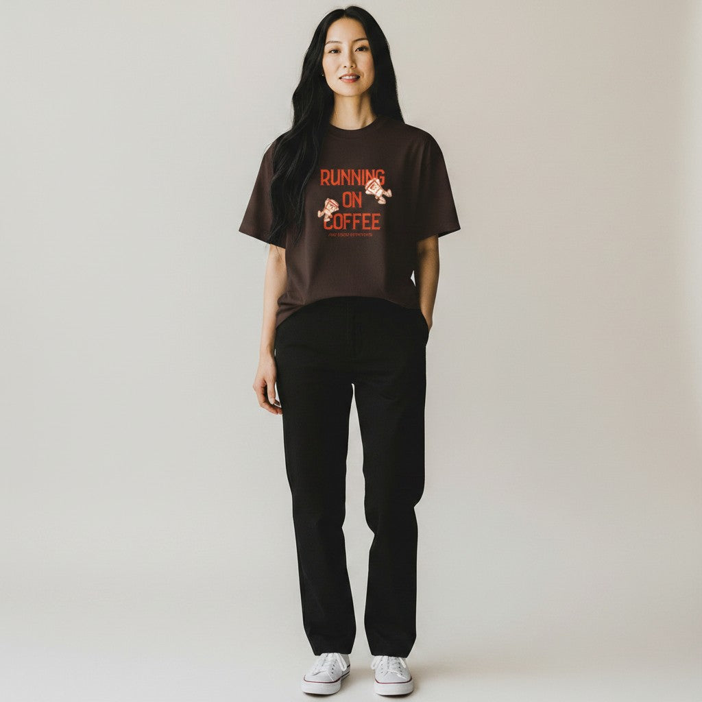 Jena Jewelry brown 100% cotton t-shirt with "Running on Coffee and Good Intentions" graphic. Features cartoon coffee cups.