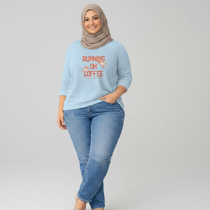 Jena Jewelry light blue 100% cotton t-shirt with "Running on Coffee" graphic and cartoon coffee cups.