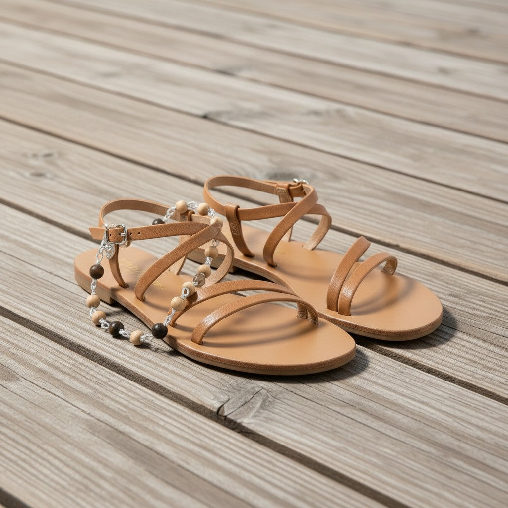 Jena Jewelry tan leather flat sandals with adjustable ankle strap and decorative sandalwood and ebony blackwood beads.
