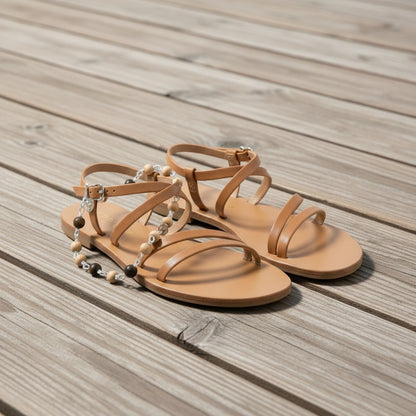 Jena Jewelry tan leather flat sandals with adjustable ankle strap and decorative sandalwood and ebony blackwood beads.