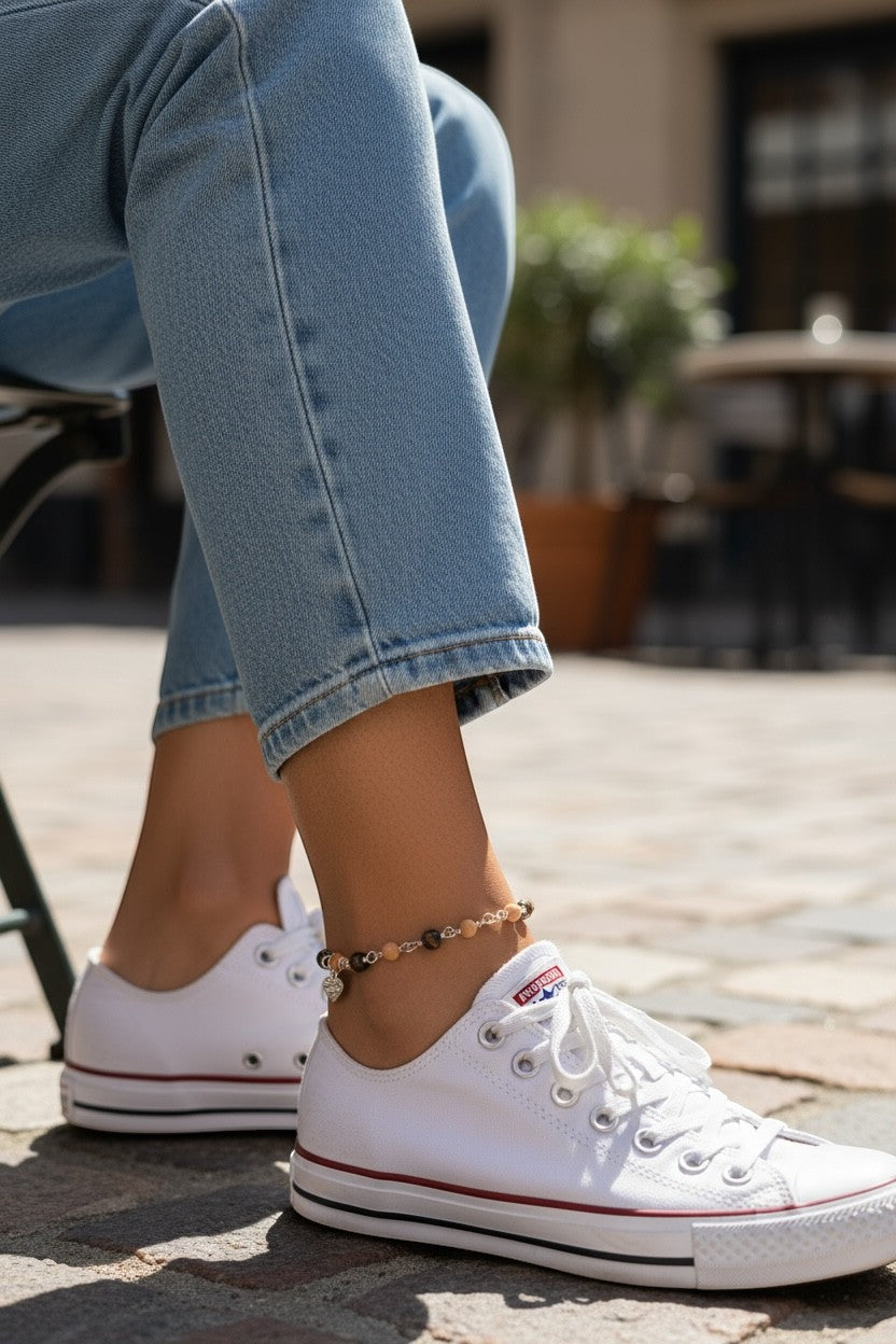 Jena Jewelry Sandalwood & Ebony Blackwood Mala Anklet with silver heart charm on a woman's ankle, paired with white sneakers.