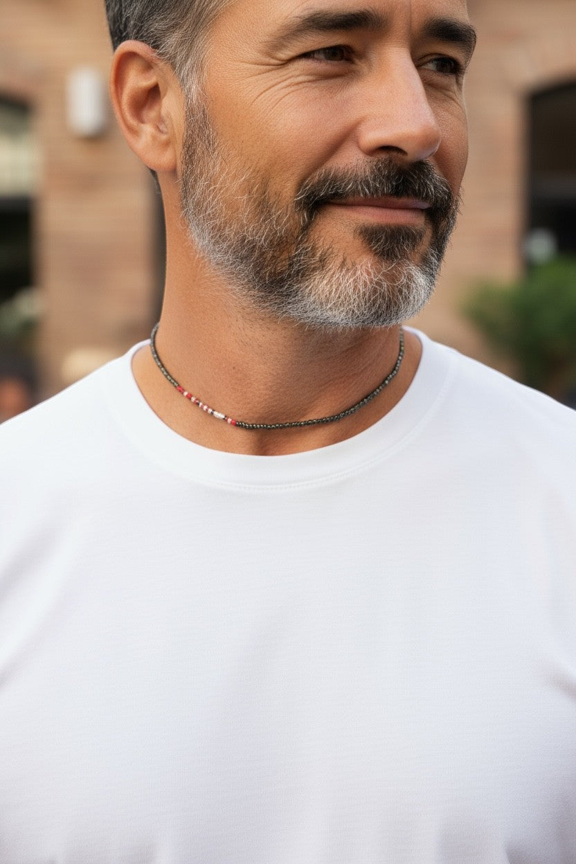 Jena Jewelry men's seed bead choker necklace with dark grey beads and a small section of red and white beads.