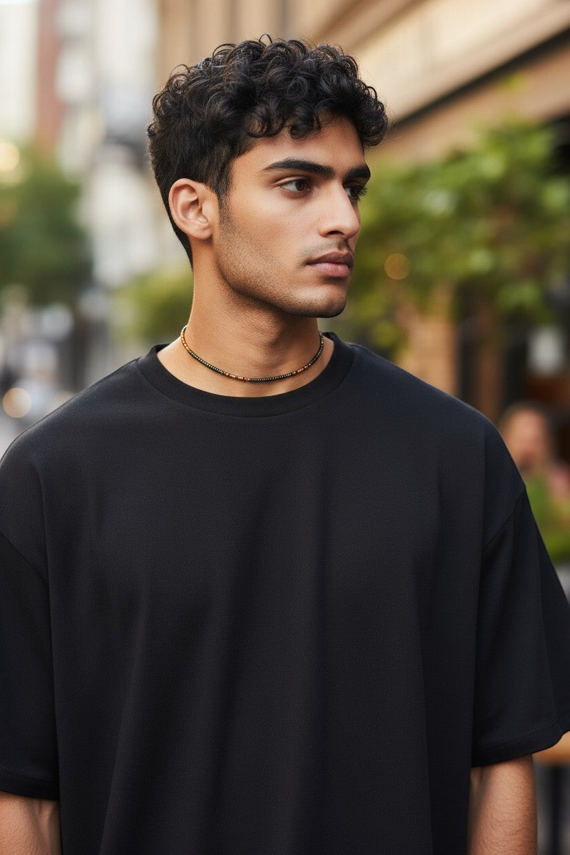 Jena Jewelry men's seed bead necklace in brown and black, worn with a black t-shirt.