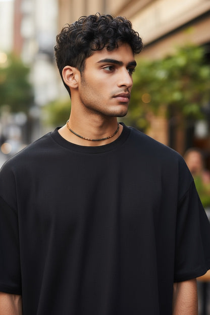 Jena Jewelry men's seed bead necklace in brown and black, worn with a black t-shirt.