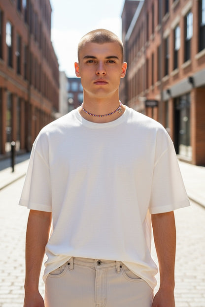 Jena Jewelry handcrafted seed bead necklace with purple and red beads, worn by a man in a white t-shirt.