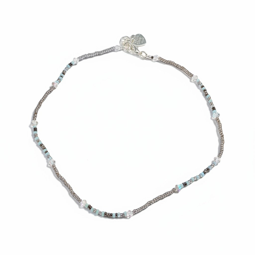 Jena Jewelry delicate seed bead necklace with white, pink, and purple beads and clear crystal accents.
