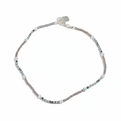 Jena Jewelry delicate seed bead necklace with white, pink, and purple beads and clear crystal accents.