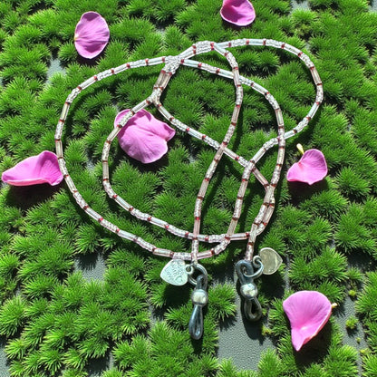 Jena Jewelry handcrafted seed bead wrap bracelet and glasses holder with clear, silver, and red beads and silver charms.