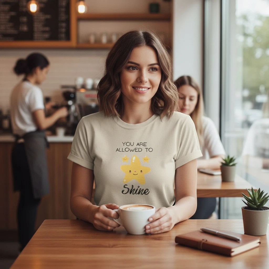 Jena Jewelry light beige 100% cotton t-shirt with "You Are Allowed to Shine" graphic and smiling stars.