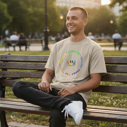 Jena Jewelry beige 100% cotton t-shirt with a circular rainbow graphic that says "Be The Reason Someone Smiles Today" and a smiley face.